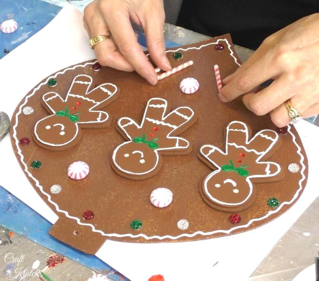 Add candy canes to the gingerbread ornament