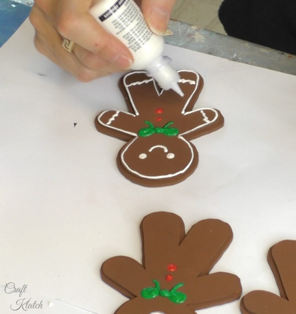 Decorating gingerbread men with fabric paint