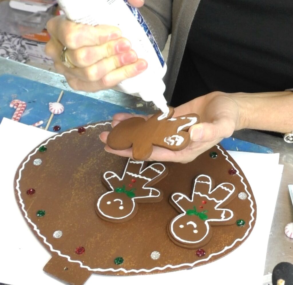 Glue gingerbread man onto Christmas ornament