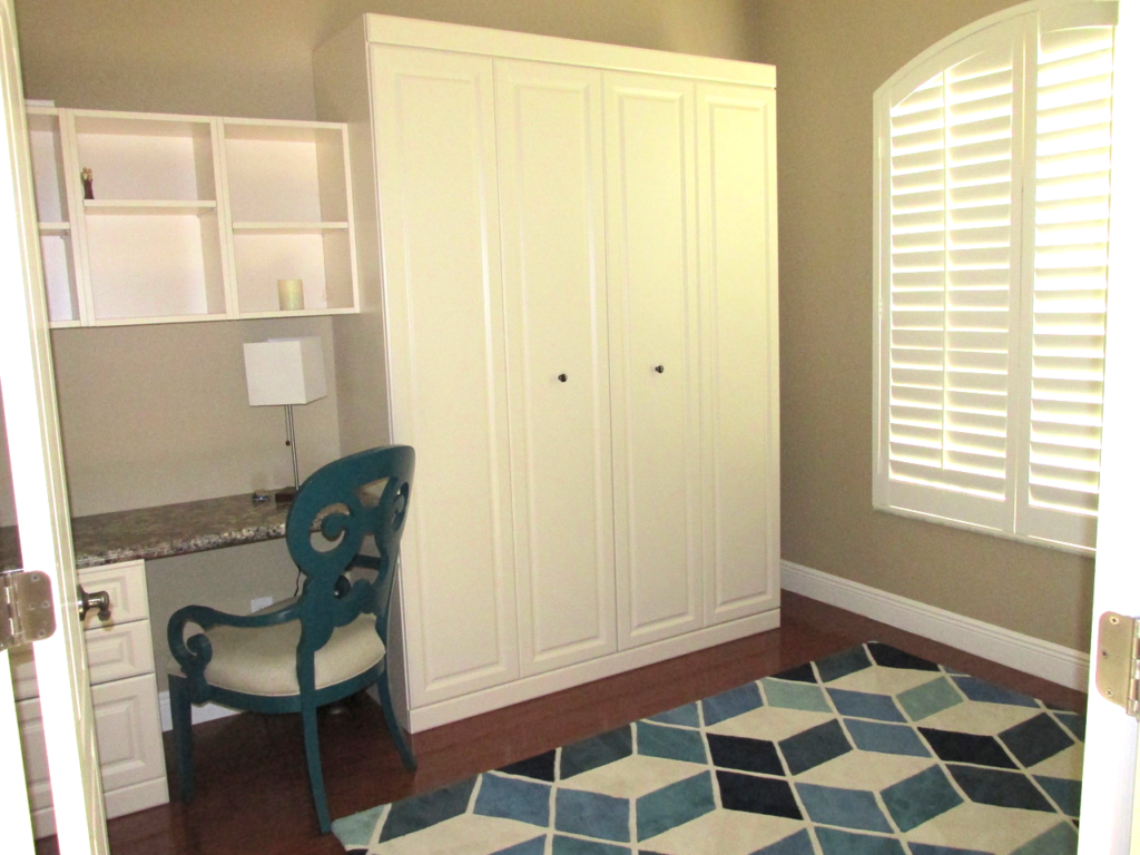 Home office with white Murphy Bed folded up