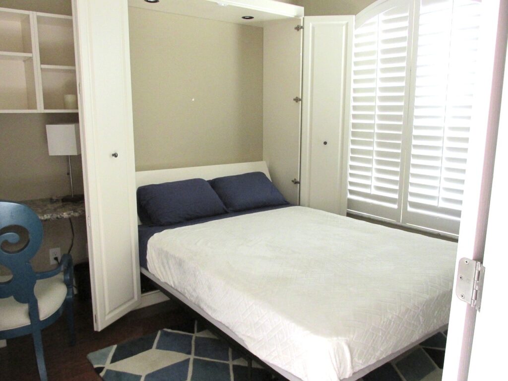 Home office with Murphy Bed pulled down for guest bedroom.