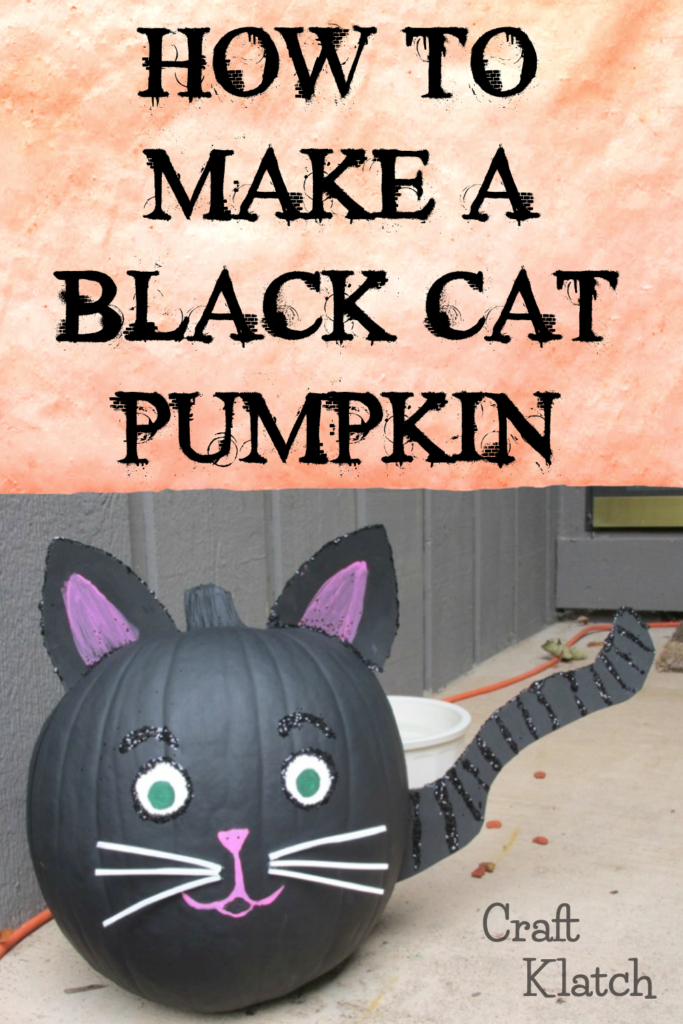 Black cat painted pumpkin with striped tail and pink ears