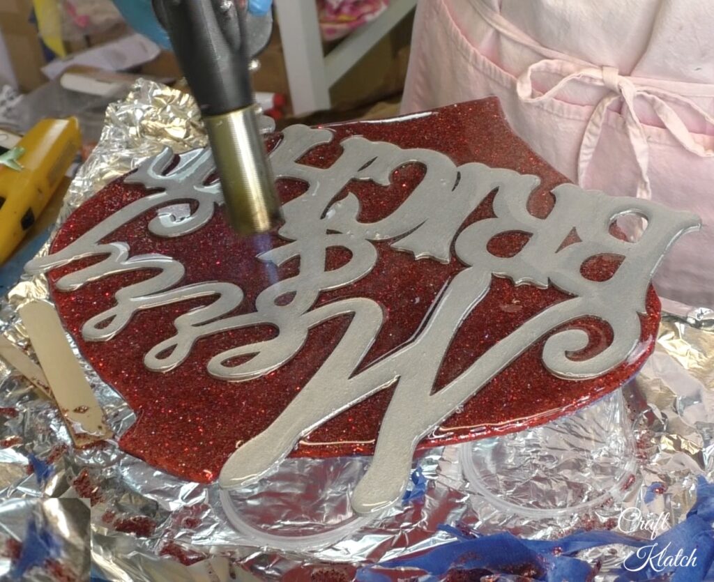 Dollar Tree Ornament Makeover #2 and this time we added glitz and glam to the Christmas decoration tutorial! A little resin and glitter make holiday art! Fun Christmas craft ideas! #craftklatch #craftideas #chiristmas #christmascrafts #resin #resinart #dollartree #dollartreecrafts #dollartreediys