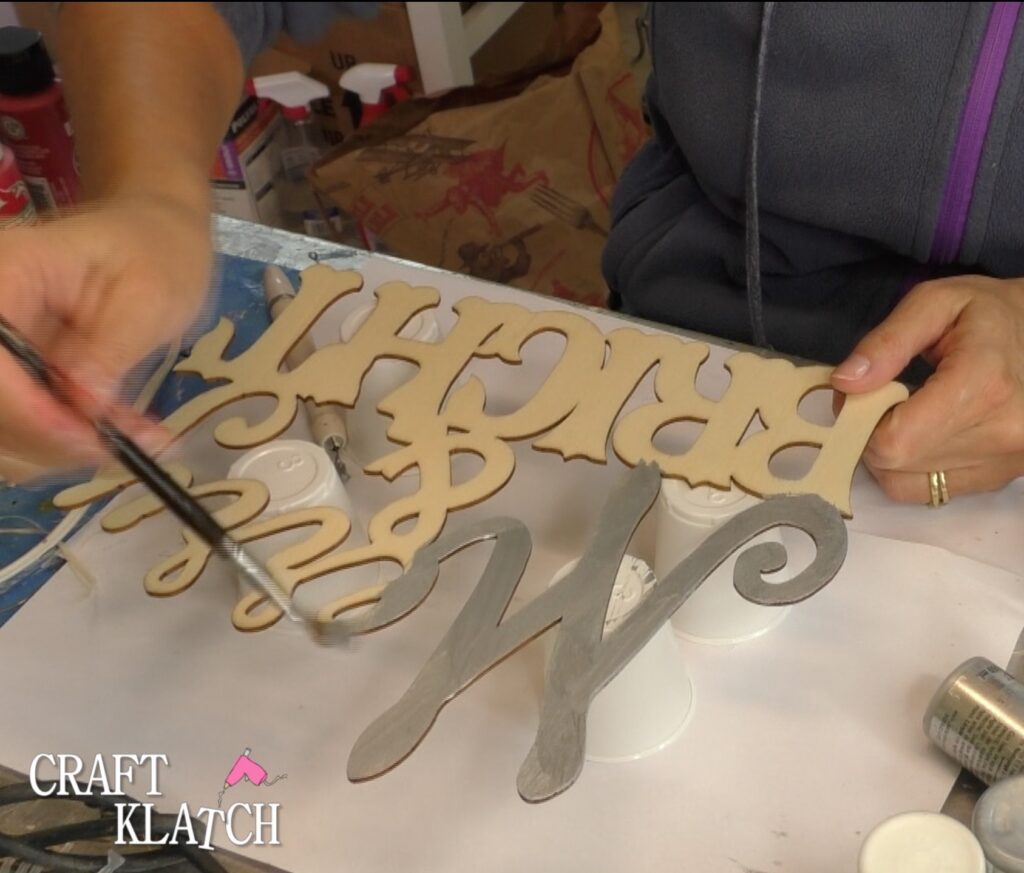 Dollar Tree Ornament Makeover #2 and this time we added glitz and glam to the Christmas decoration tutorial! A little resin and glitter make holiday art! Fun Christmas craft ideas! #craftklatch #craftideas #chiristmas #christmascrafts #resin #resinart #dollartree #dollartreecrafts #dollartreediys Painting wood Merry and Bright silver