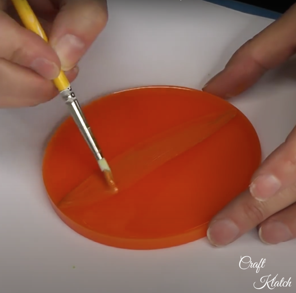 Painting orange definition lines on the orange pumpkin coaster