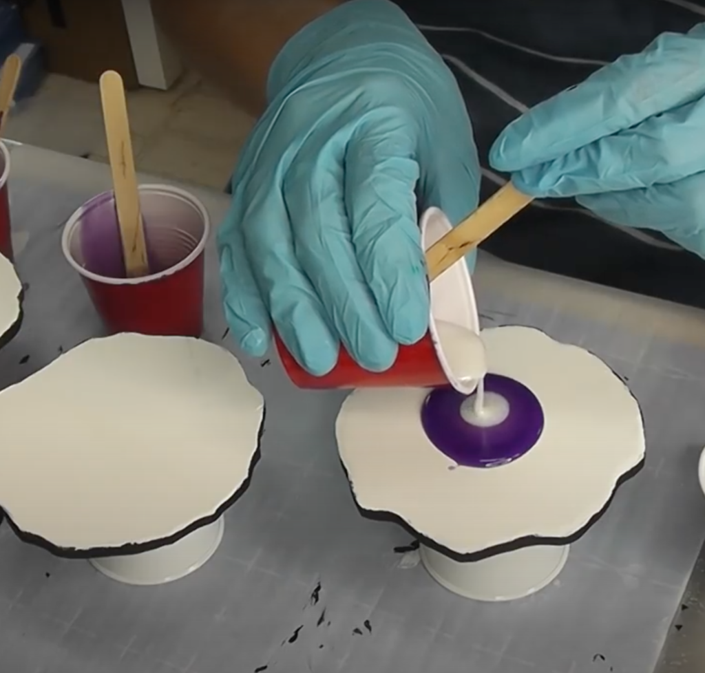 Pouring purple and white resin on geode coasters base