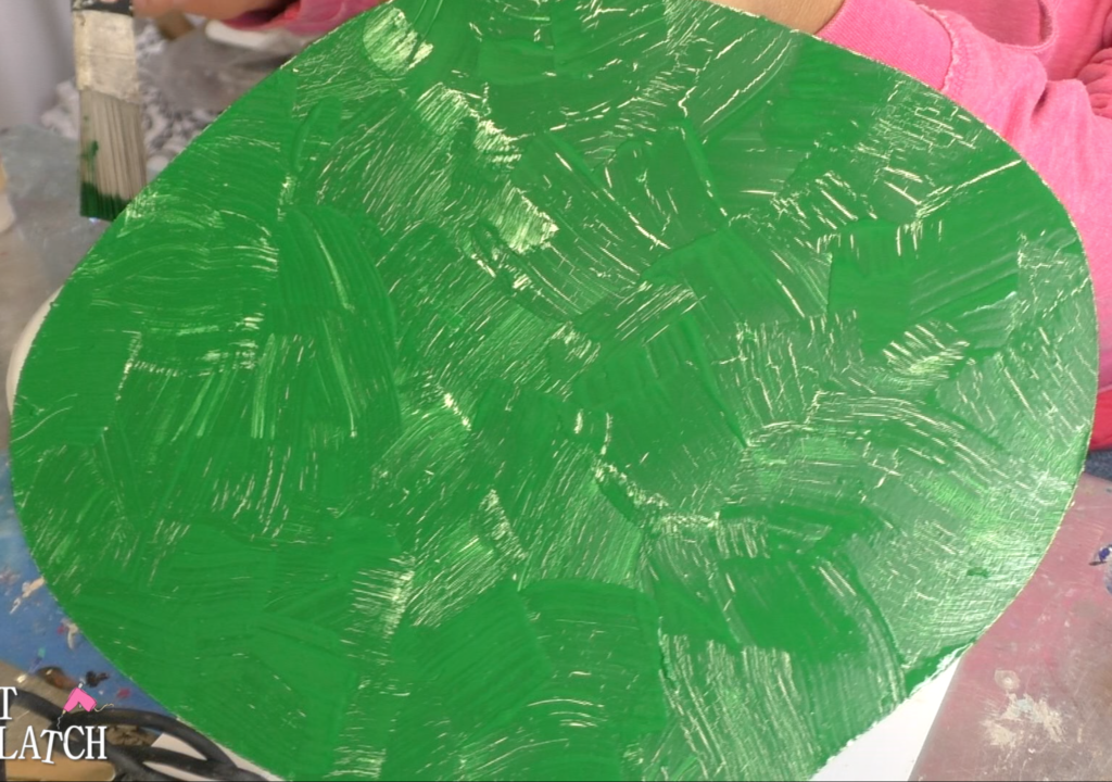 Cream crackles showing through the green paint