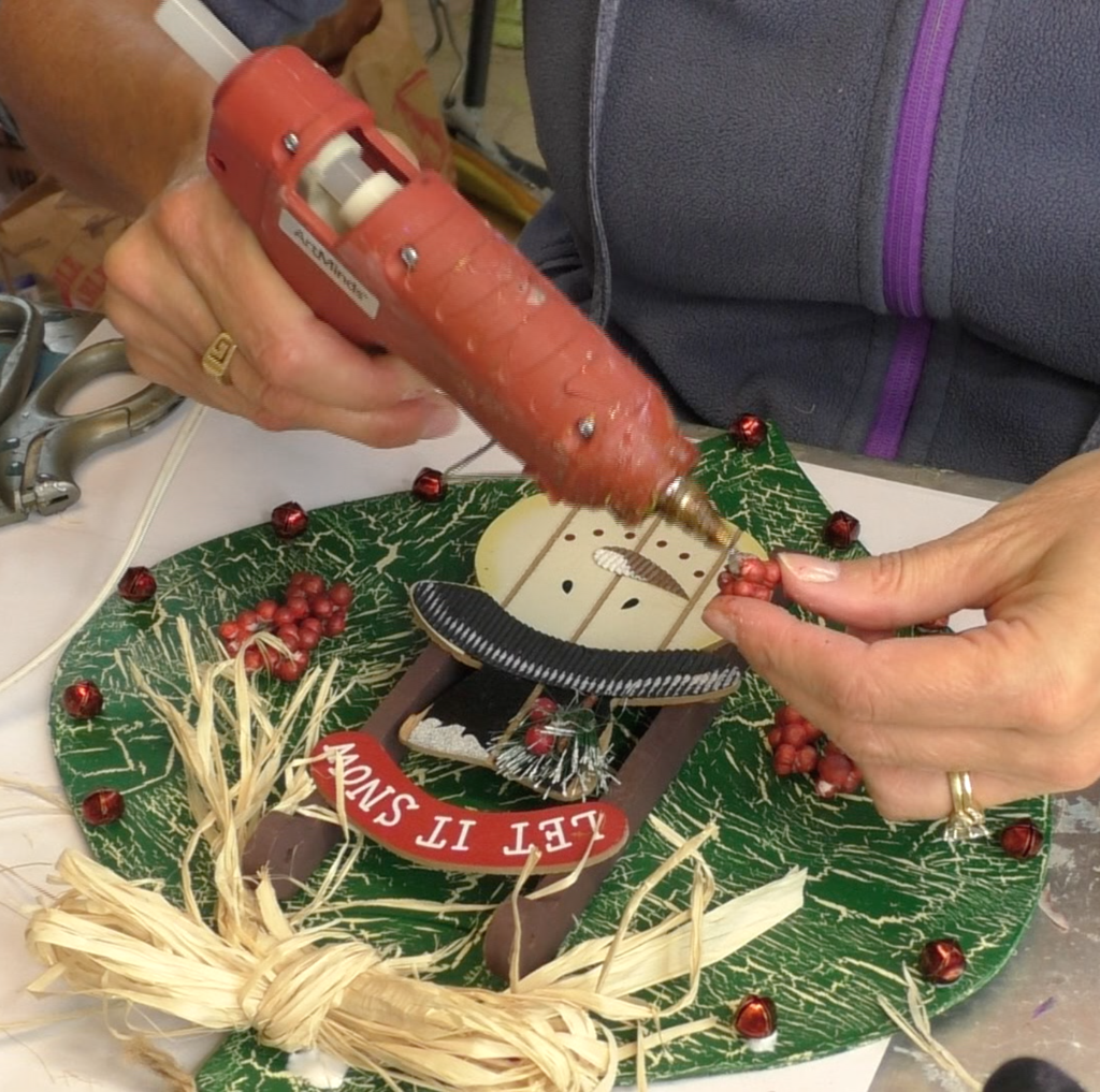I found this ornament at Dollar Tree, in fact I found four! I decided I would style the ornament four different ways! This is the first and I'm going for a Rustic Snowman Christmas Ornament DIY! Dollar store crafts are a great way to decorate on a budget and customize your Christmas decorations to reflect your personal style and home decor ideas! #craftklatch #holidaydecorations #dollartree #dollartreecrafts #christmas #christmascraft #christmascraftideas #diy #craft #crafts #crafting #craftideas #howto #christmasdecor, Gluing red berries onto ornament