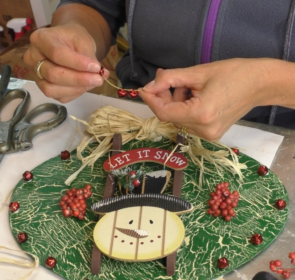 I found this ornament at Dollar Tree, in fact I found four! I decided I would style the ornament four different ways! This is the first and I'm going for a Rustic Snowman Christmas Ornament DIY! Dollar store crafts are a great way to decorate on a budget and customize your Christmas decorations to reflect your personal style and home decor ideas! #craftklatch #holidaydecorations #dollartree #dollartreecrafts #christmas #christmascraft #christmascraftideas #diy #craft #crafts #crafting #craftideas #howto #christmasdecor, Adding jingle bells to a gold wire