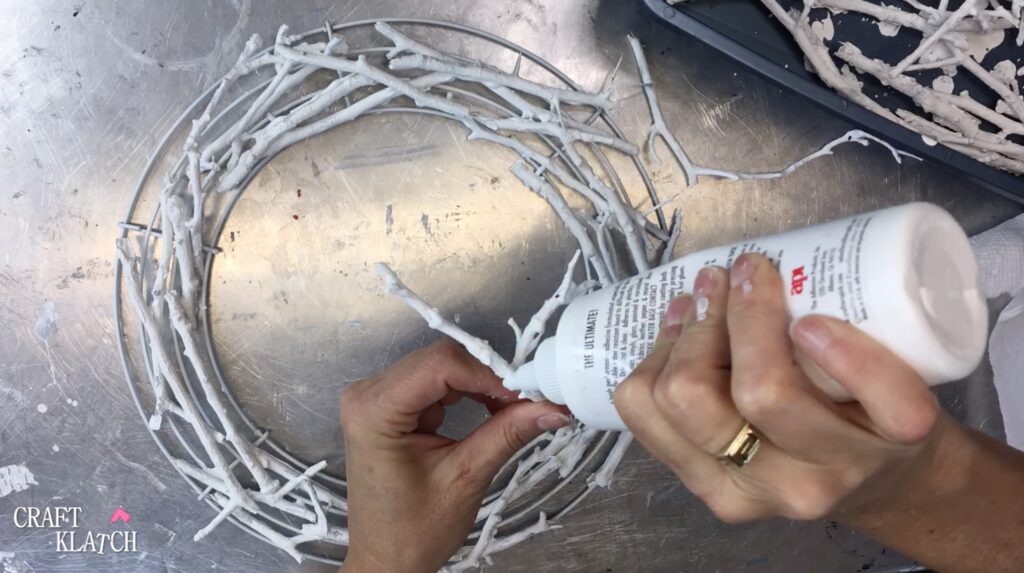 how to make a twig Christmas wreath by gluing white twigs onto wreath form