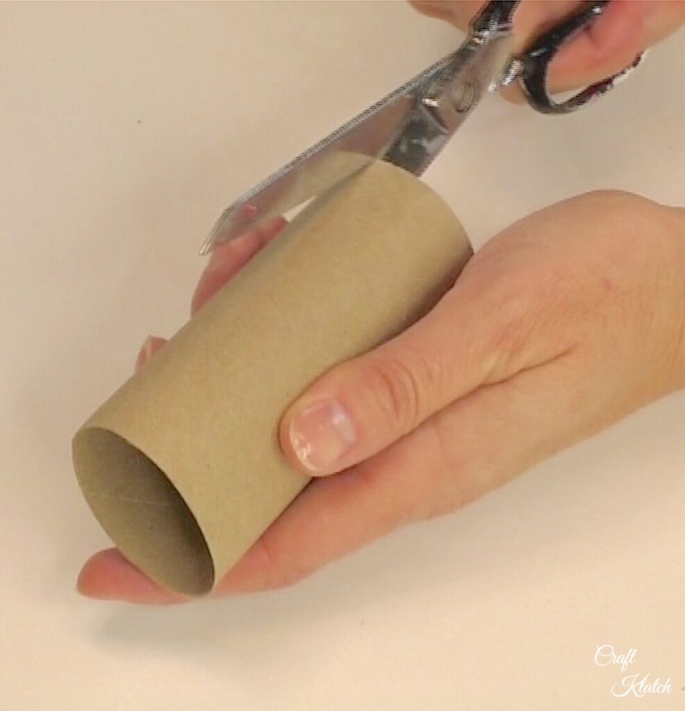 Cut toilet paper roll lengthwise