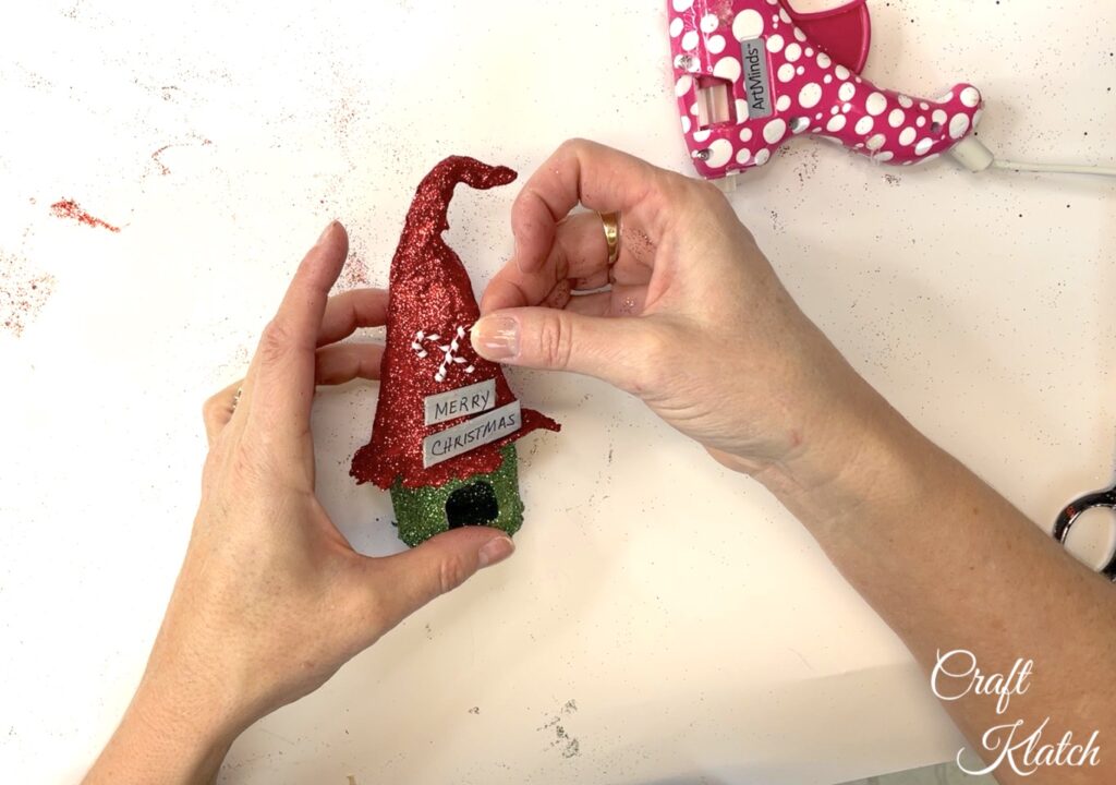 Glue candy canes onto the enchanted birdhouse craft