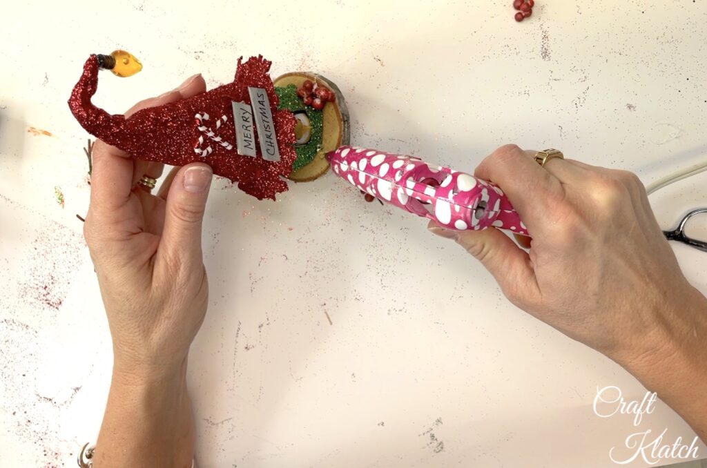 Glue on red berries to the how to make an enchanted birdhouse christmas ornament