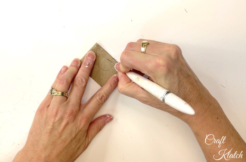 Use craft knife to cut an opening out of toilet paper roll