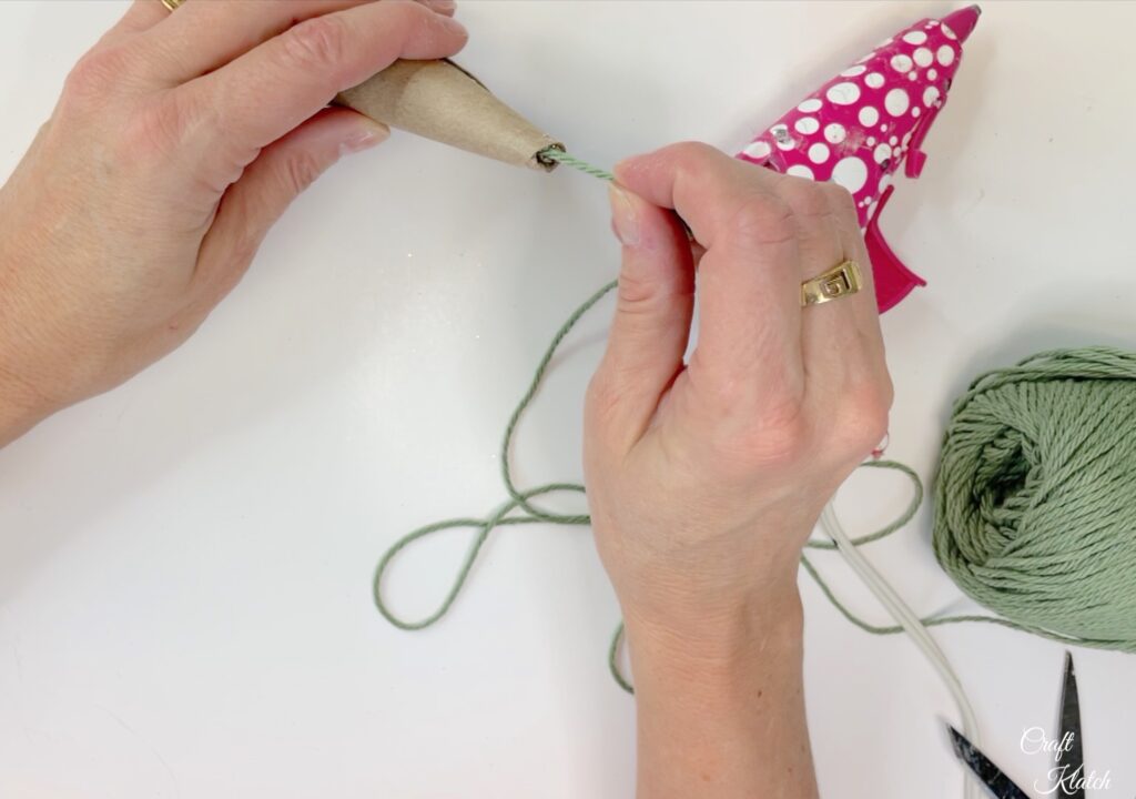 Glue green yarn into top of toilet paper christmas tree ornament