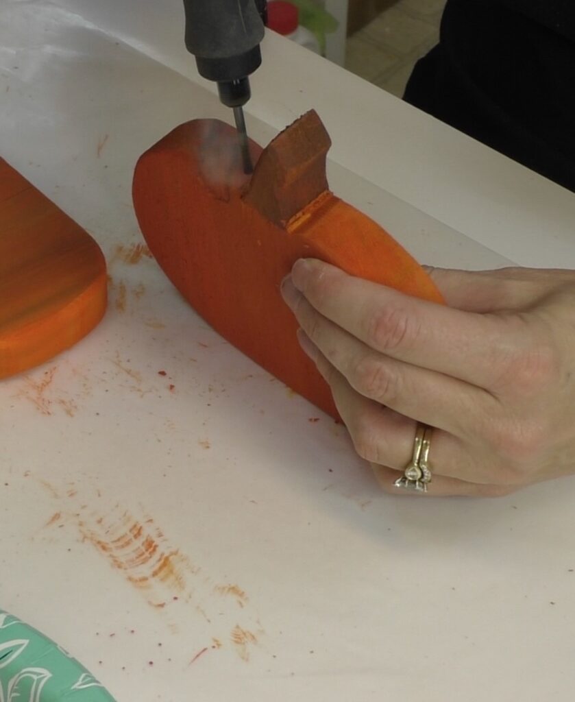 Drilling hole in wood pumpkin