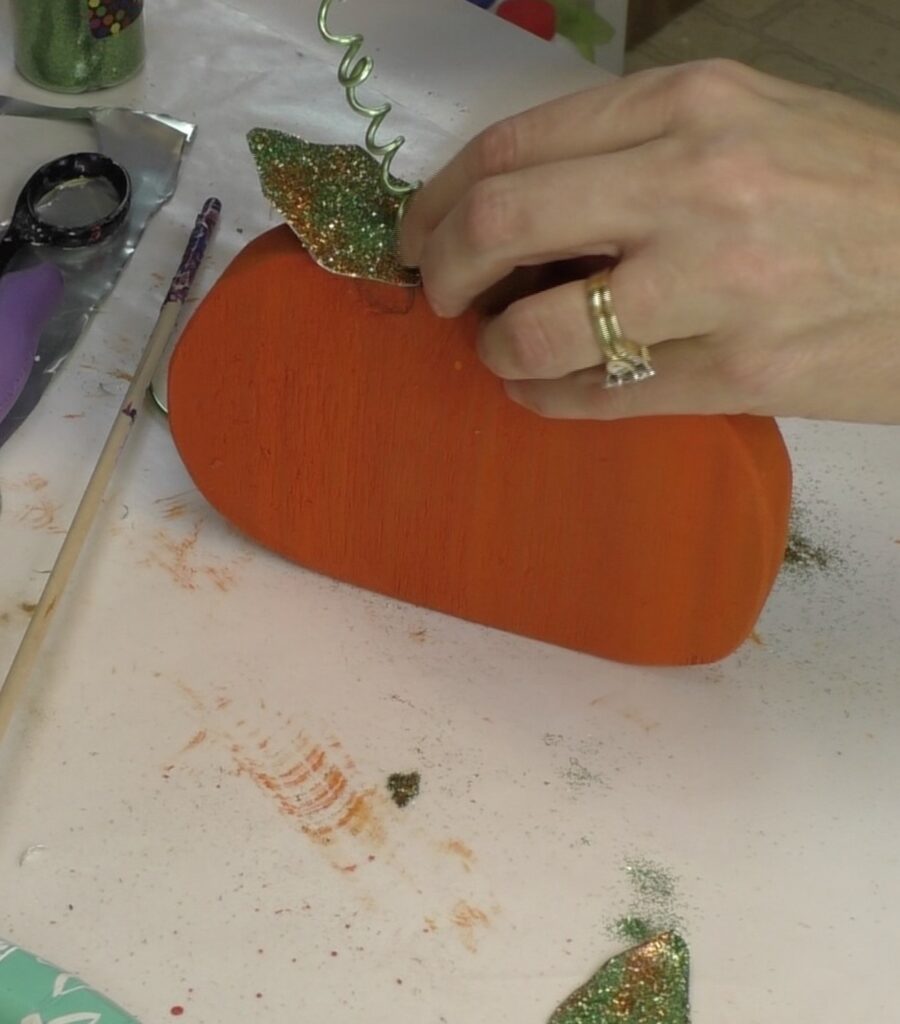 Adding wire tendril to wood pumpkin