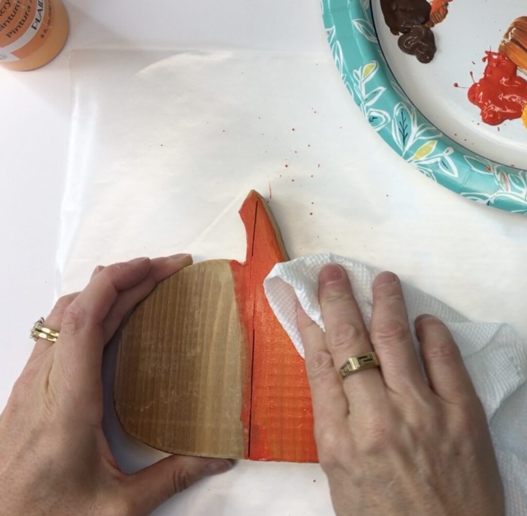 Wiping excess paint off of Thanksgiving craft