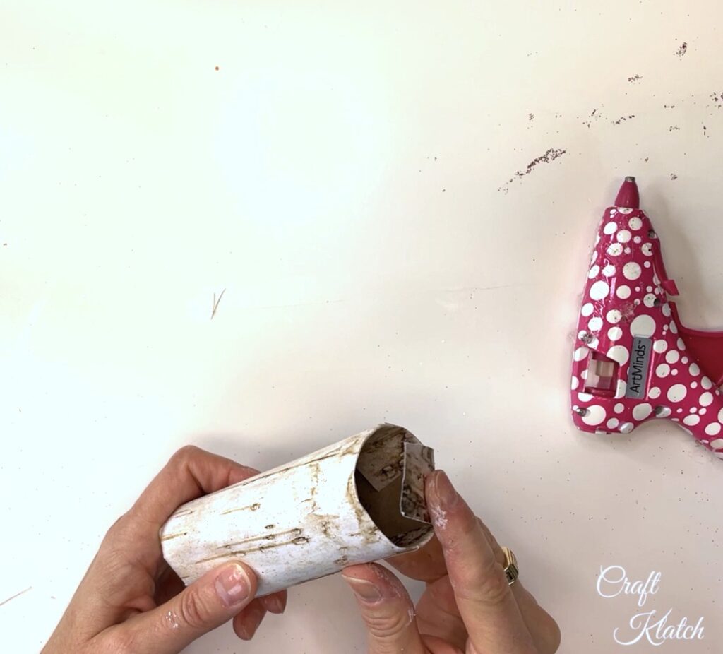 Fold flaps down into the toilet paper roll for the bird Christmas tree ornament