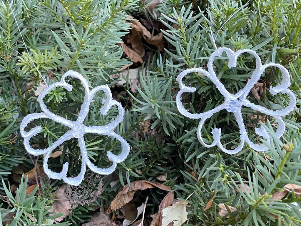 Paper snowflake ornaments hanging in tree