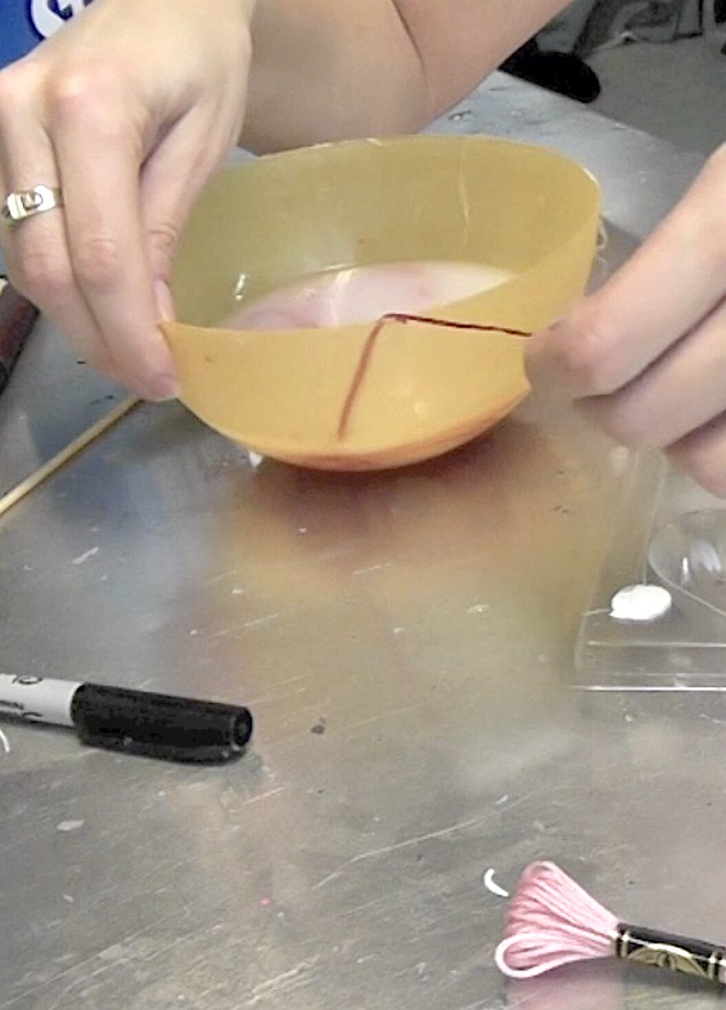 Red embroidery floss in bowl of starch for string art heart