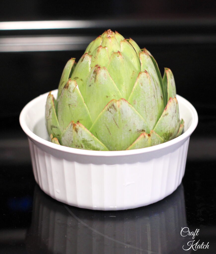 To cook an artichoke in microwave place it in a microwave safe dish