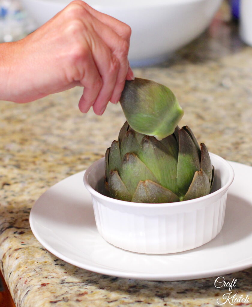 Pull the leaves out of the artichoke