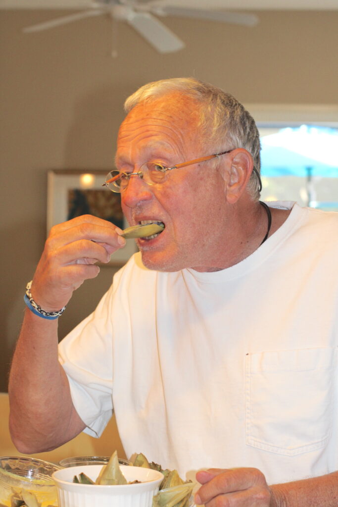 Greg eating an artichoke