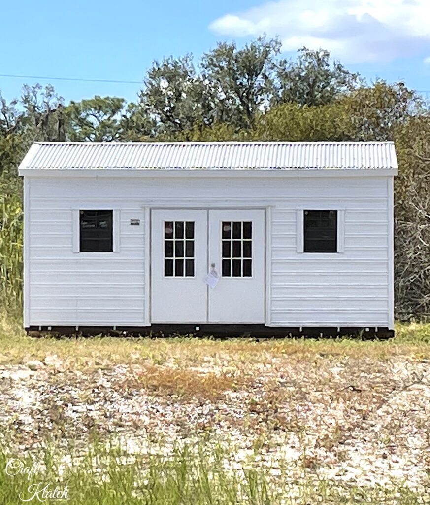 white she shed placed on lot