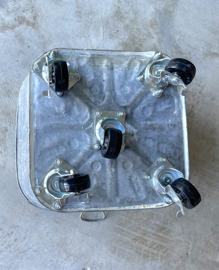 Casters attached to the bottom of galvanized tub for the DIY cat tree