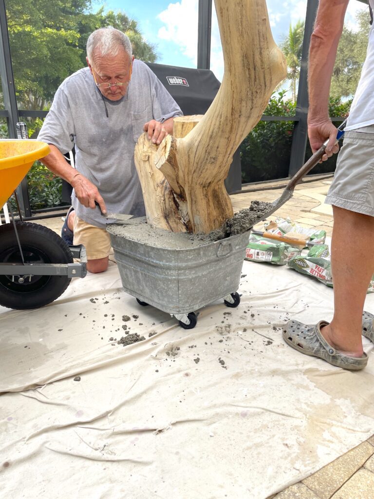 Greg and Dad adding concrete to the metal tub for the diy cat tree base
