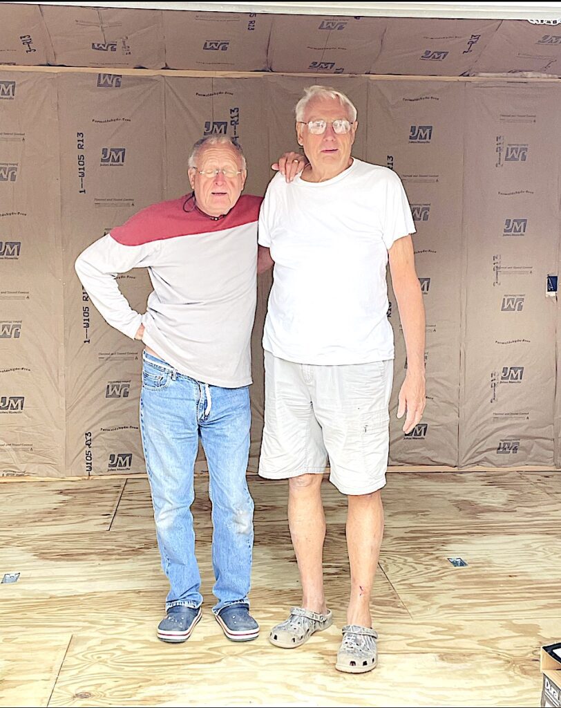 Greg and Dad standing in doorway of shed