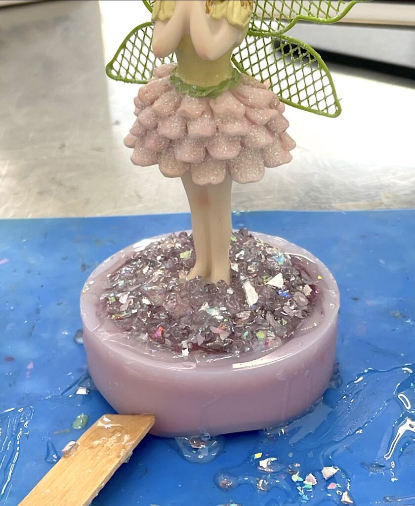 Feet of tooth fairy covered with glass and resin