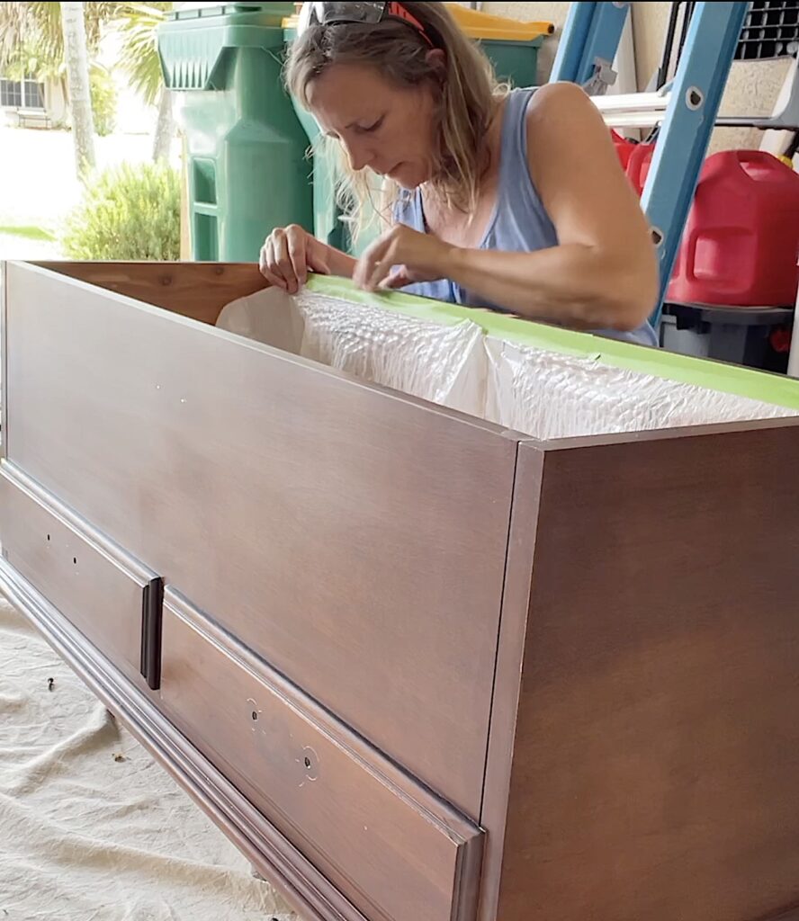 Taping garbage bags inside to protect cedar chest