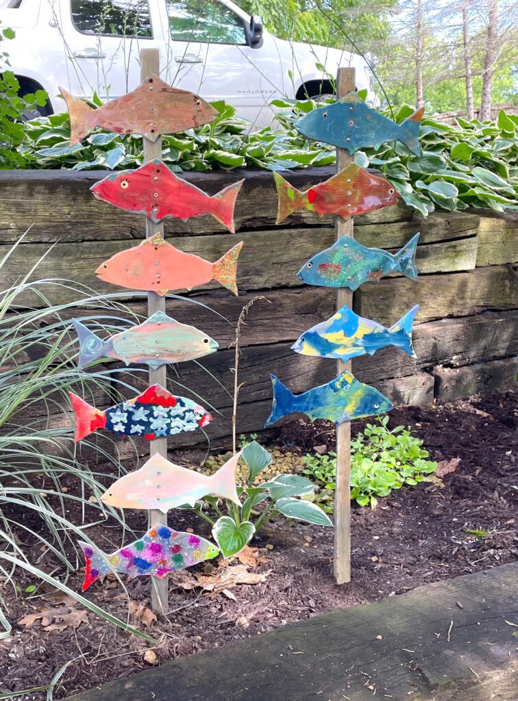 Family tradition fish sticks in flower bed