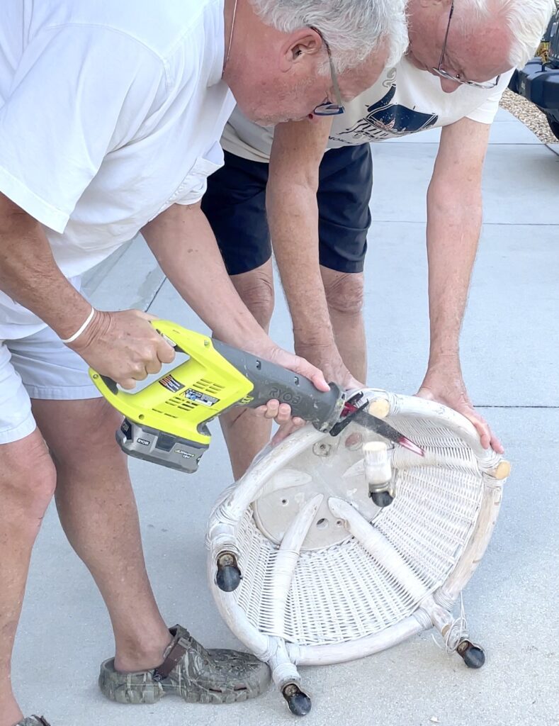 Greg and Dad using the Sawsall to cut off legs of the Christmas tree base craft