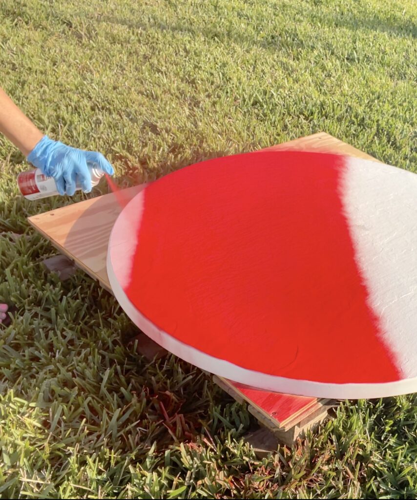 Spray painting table top with Rustoleum's apple red