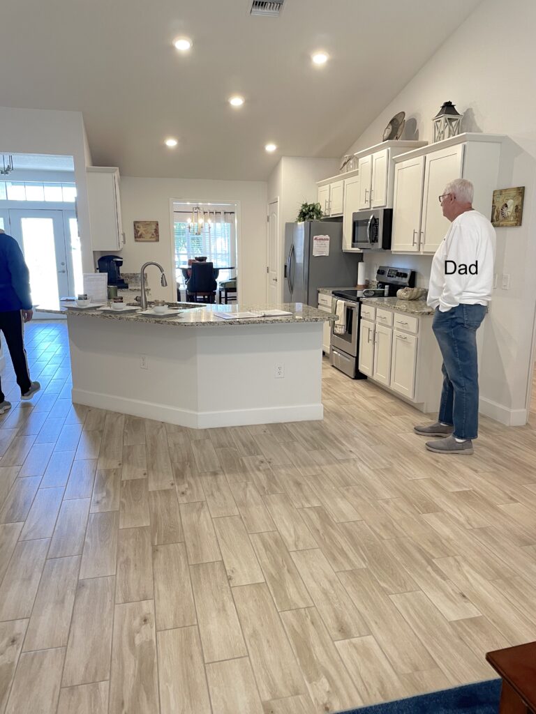 White Open kitchen design with partial kitchen island