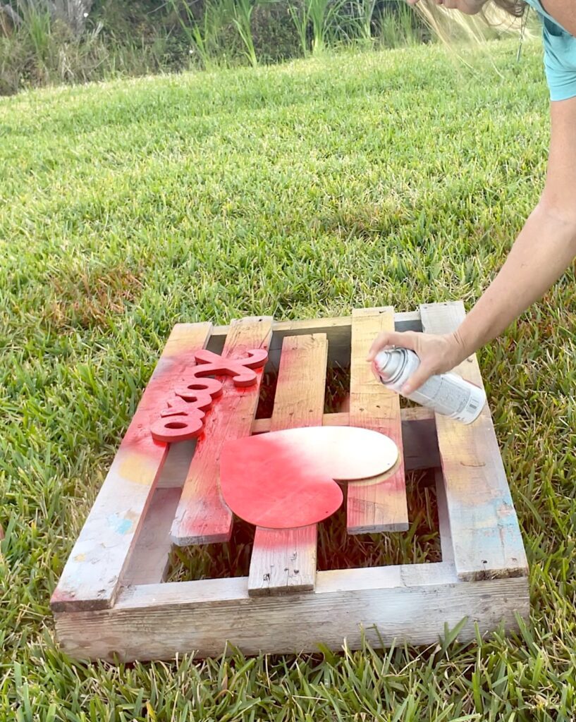 Painting Valentine's Day decor with red spray paint