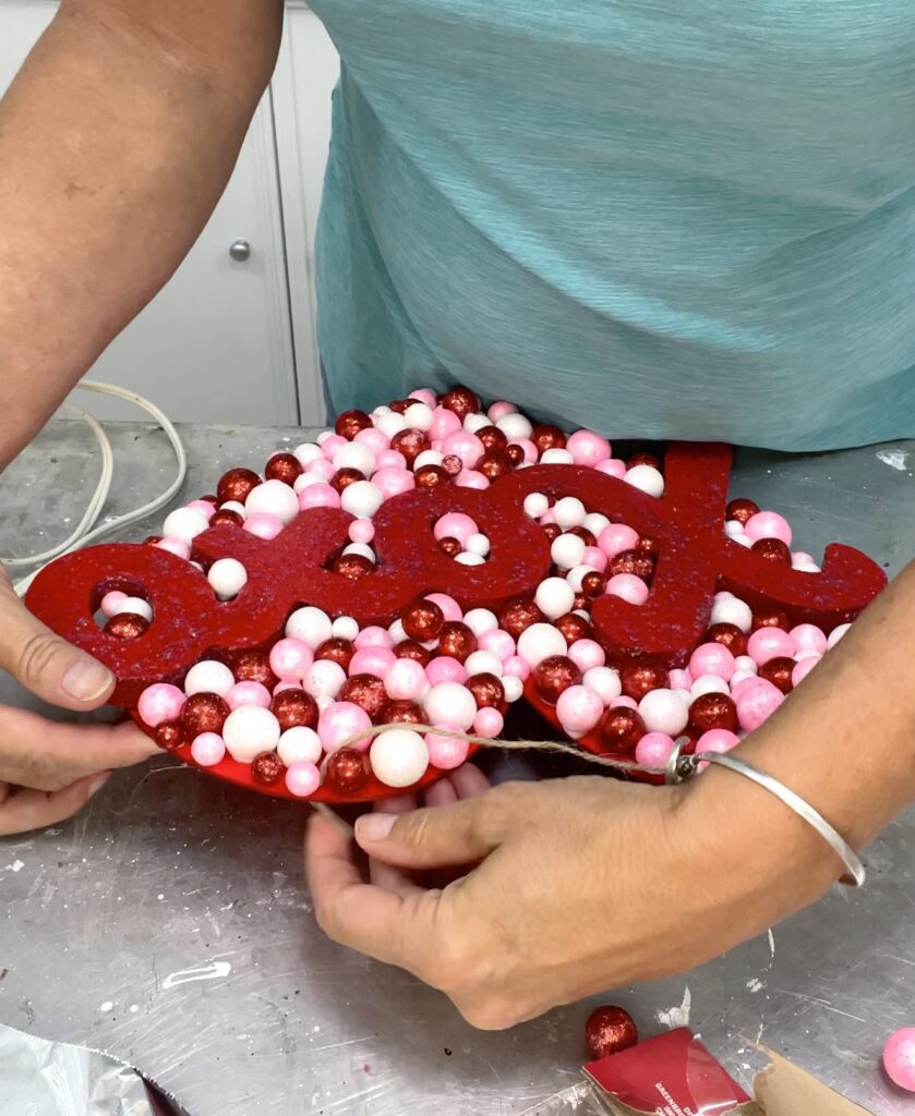 Reattach the jute string to the Valentine's Day decor heart