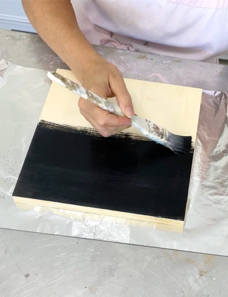 Paint the wood canvas panel black