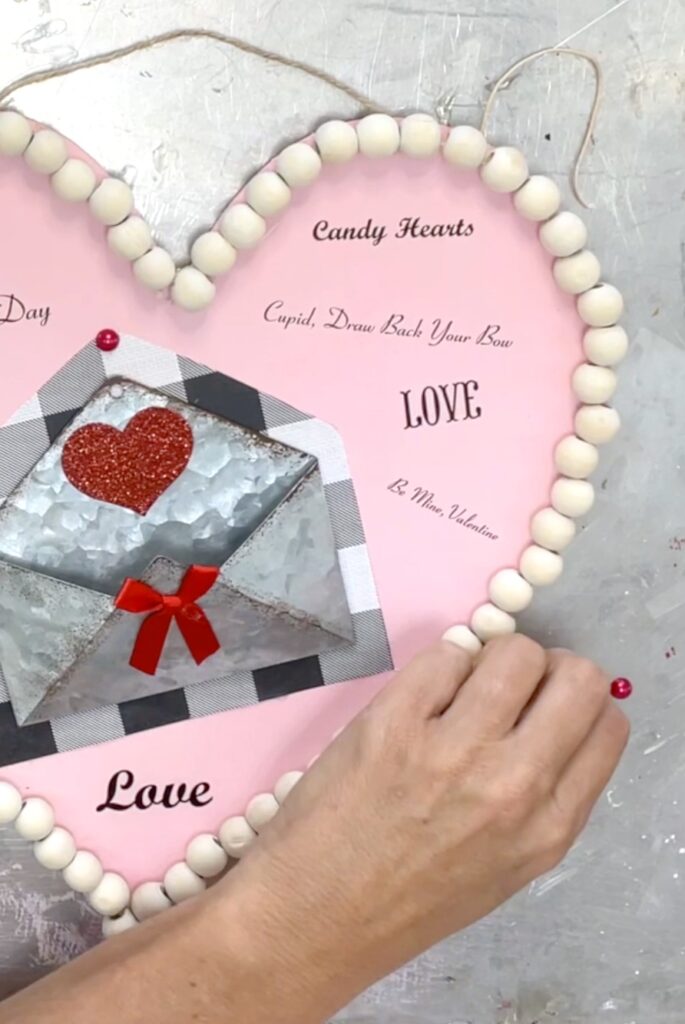 Glue red half pearls onto the heart Valentine craft idea