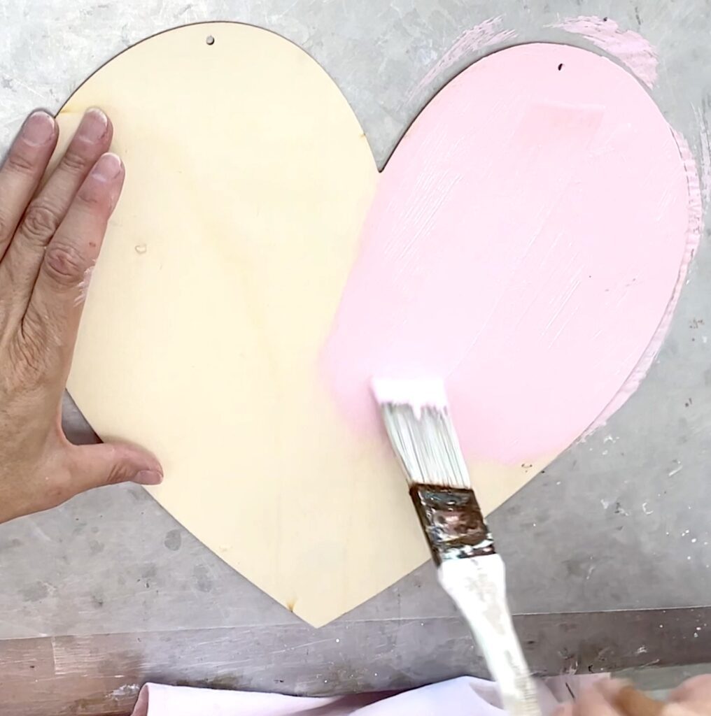 Painting wood heart pink for the Valentine craft idea