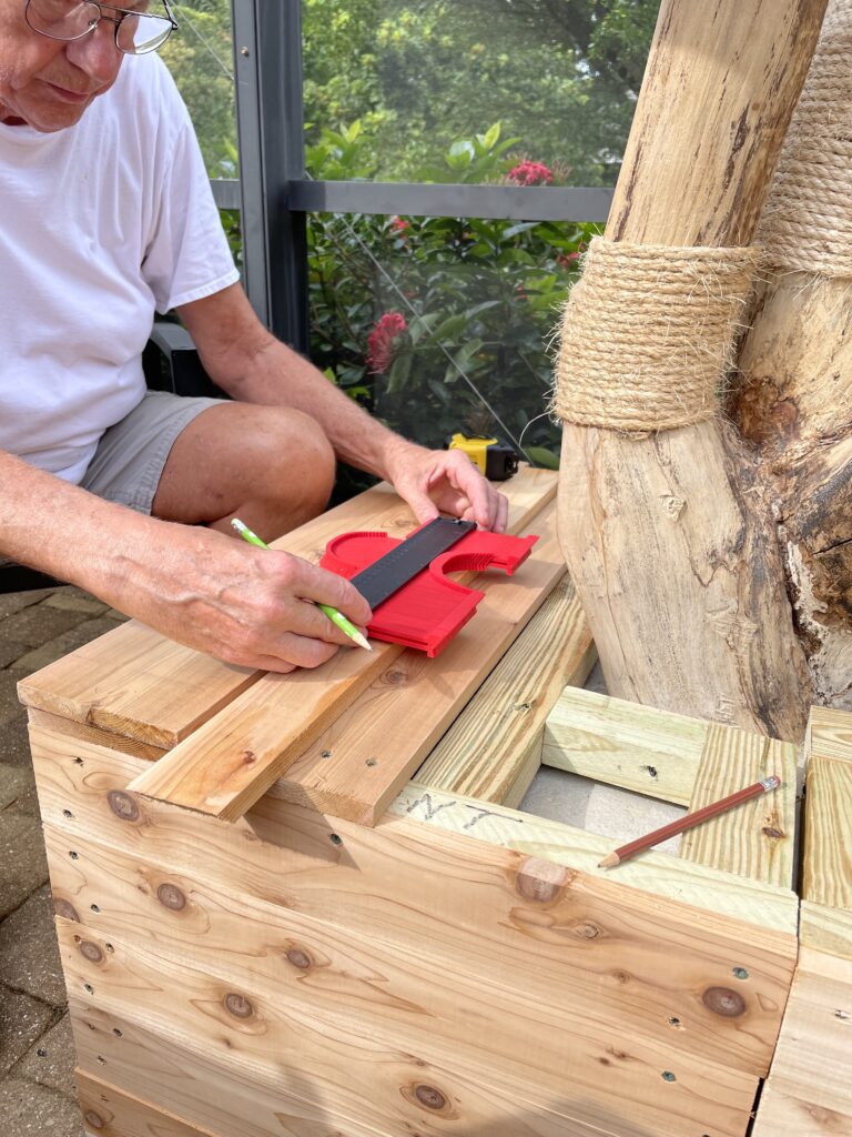 Dad precisely shaping the base cover so the tree could poke out