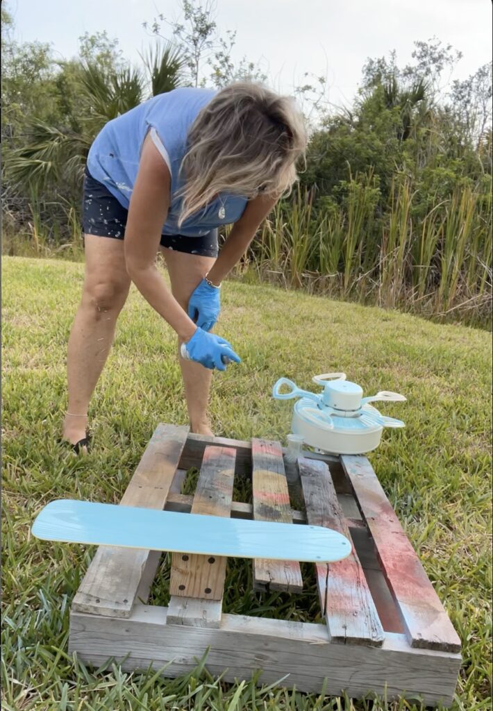 Spray painting the base of the ceiling fan