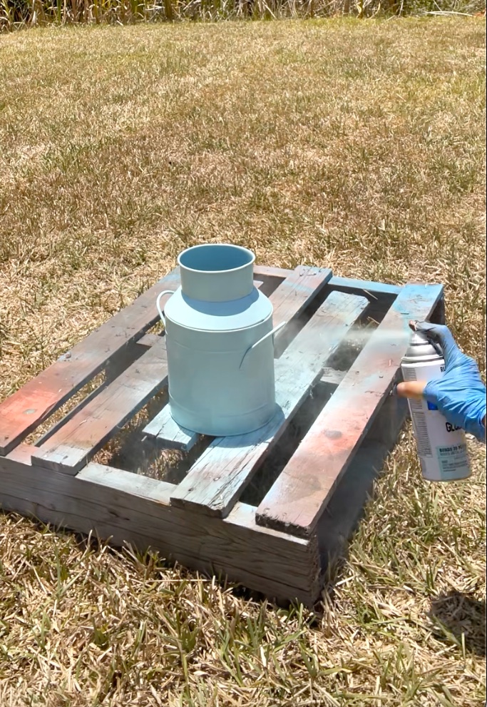 Spray painting the milk jug aqua