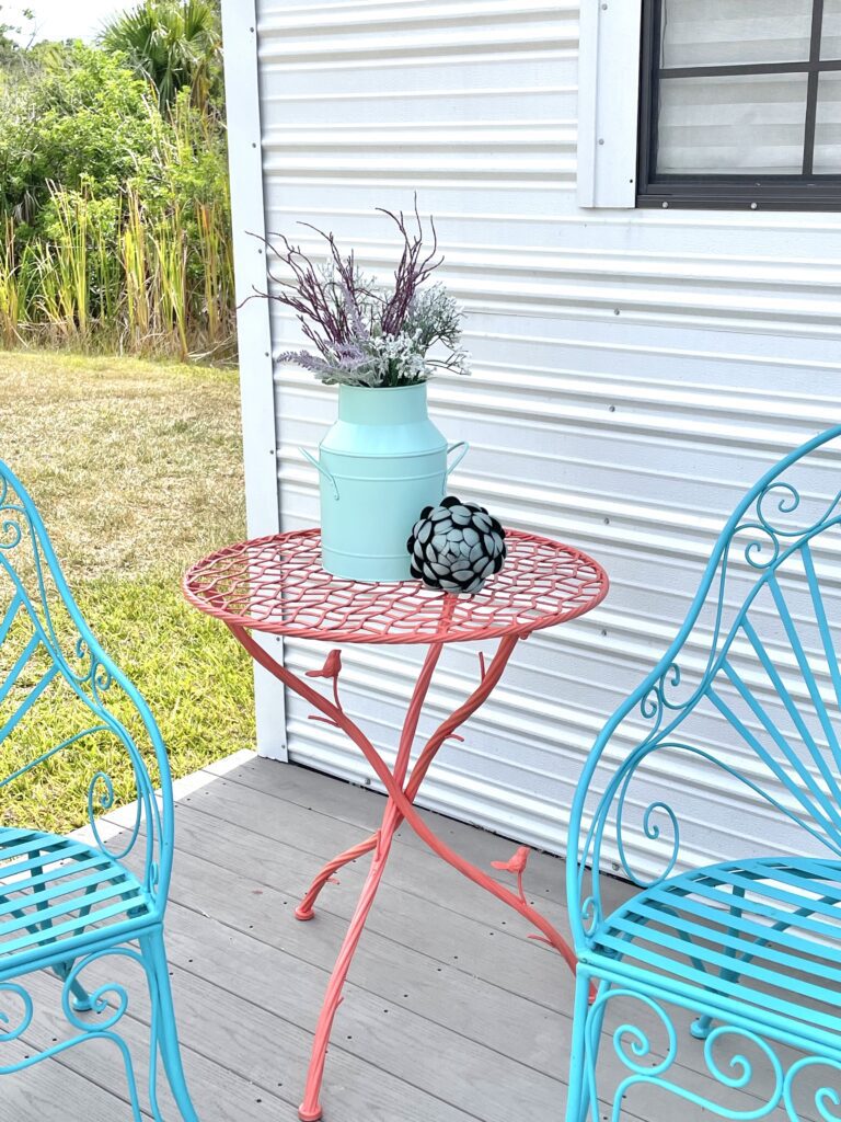 Upcycled bird table furniture salvage with blue chairs
