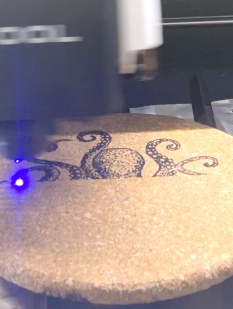 octopus image being engraved onto the cork coasters with the xTool M1