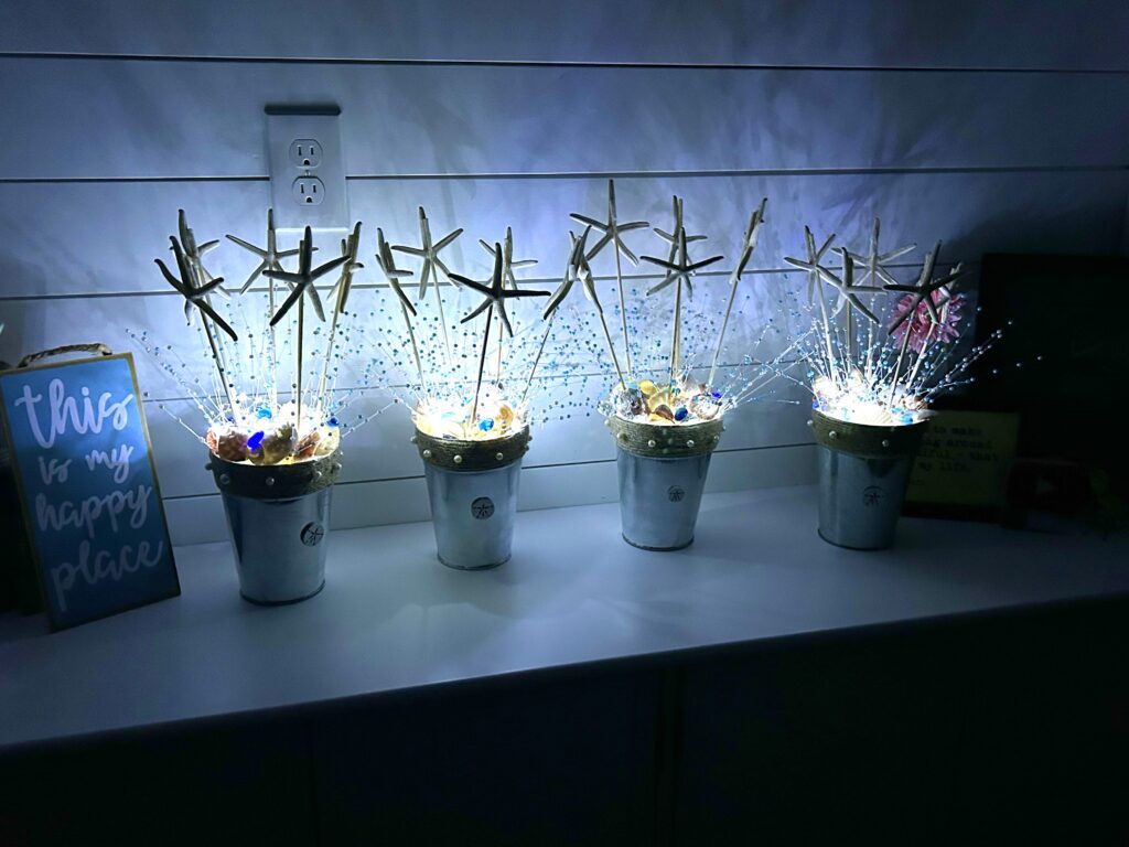 Finished beach bridal shower centerpieces lit up with fairy lights