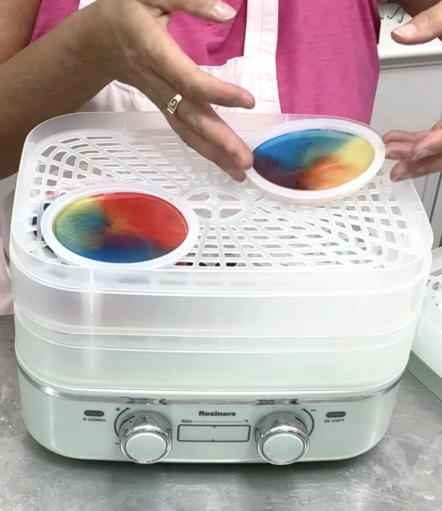 Placing uncured resin coasters in the Resiners curing machine